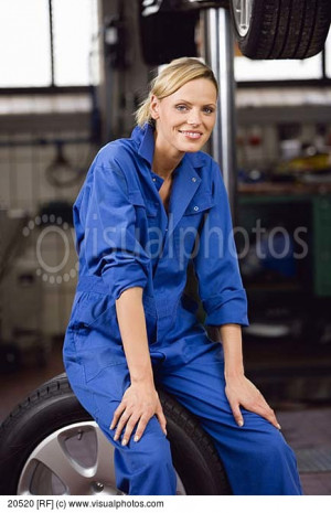 Female Mechanic Sitting On Car Wheel 20520 > Stock Photos Royalty