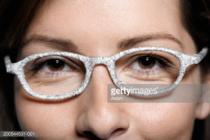Stock Photo : Woman wearing glasses wrapped in stock quotes, close-up ...