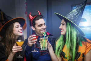 Halloween witches and devil toasting cocktails - Betsie Van Der Meer ...