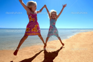 Two Girls having fun on a tropical beach - Stock Image