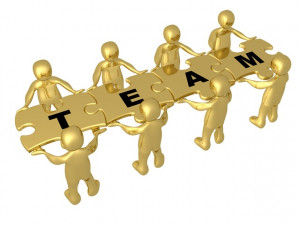 Team Of 8 Gold People Holding Up Connected Pieces To A Colorful Puzzle ...