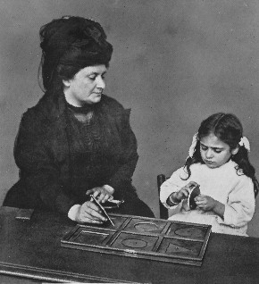 DR. MONTESSORI GIVING A LESSON IN TOUCHING GEOMETRICAL INSETS
