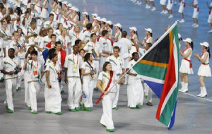 Olympic team follow their national flag-bearer Natalie Du Toit ...