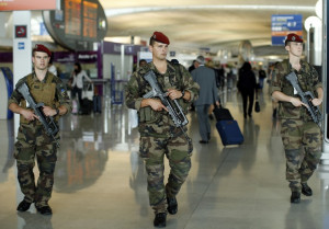 French soldiers patrol through a terminal at the Charles de Gaulle ...