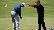 Tiger Woods works with golf instructor Sean Foley on the practice ...