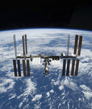 The International Space Station is visible against the Earth's horizon ...