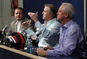 Broncos vice president John Elway, center, is flanked by head coach ...