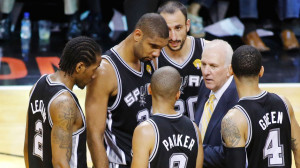 San Antonio Spurs head coach Gregg Popovich speaks to his players near ...