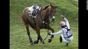 Japan's Yoshiaki Oiwa falls off his horse as he competes in the cross ...