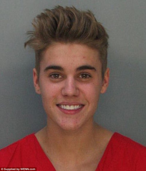 Carefree: Justin Bieber smiles for one of his mugshots