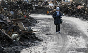 Reuters reporter Yoko Kubota walks among the rubble of the Japanese ...