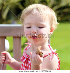 ... child, adorable blonde toddler girl in red dress messy around