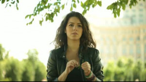 Nervous and beautiful young adult woman breaks leaves.
