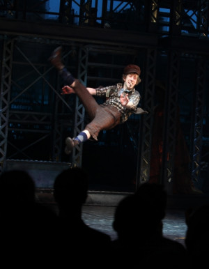 Ryan Breslin leaps at the opening-night curtain call of 