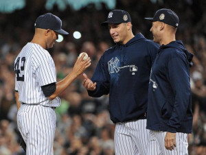 New York Yankees relief pitcher Mariano Rivera, left, hands the ball ...