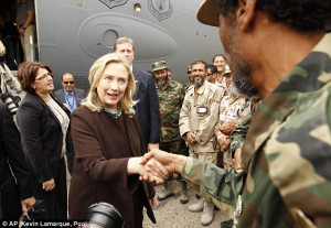Pledging help: Mrs Clinton meets Libyans soldiers at the steps of her ...
