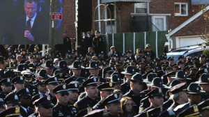 PHOTO: Law enforcement officers turn their backs on a video monitor as ...