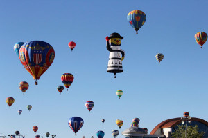 Visitors stand next to hot air balloons taking flight during the 42nd ...