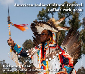 Wearing Native American eagle feather regalia and custom beadwork art.