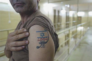 Abu Ghraib prison guard showing off his tattoo