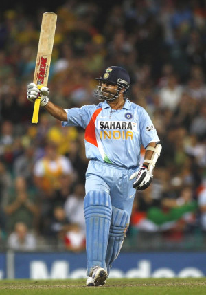Sachin after scoring his half century raising his bat towards the ...
