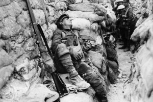 Comrades watch as a soldier gets some sleep, Thievpal, France, during ...