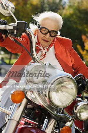 Elderly woman driving a motorcycle Stock Photo - Premium Royalty ...
