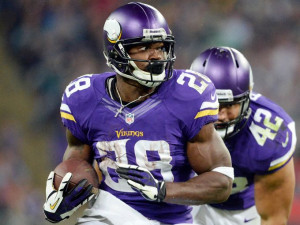 Peterson rushes against the Steelers during the Vikings' win in London ...