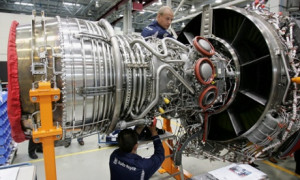 Workers assemble an aircraft jet engine at the Rolls-Royce aircraft ...