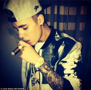 Up in smoke: The tattoo'd teen sensation, seen here with a Cuban cigar ...