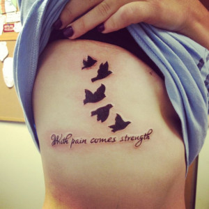 Girl showing flying Birds And Strength Tattoo On Rib