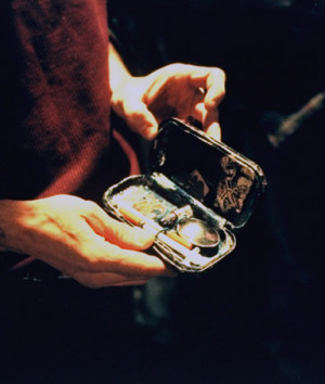 of addict displaying small case containing crank (methamphetamine ...