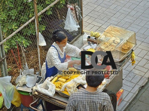 Thai street food cart offering cooked delicacies in Bangkok Thailand