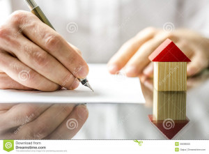 Conceptual image of a man signing a mortgage or insurance contract or ...