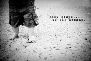 ... walking on the beach with a quote that says baby steps to big dreams