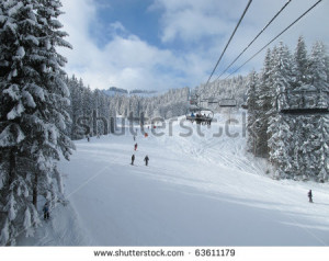 ... Snow Day Ski piste and chair lift with snow covered trees on sunny day