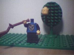 lego man shot his head off, and it is stuck to a nearby lego tree.