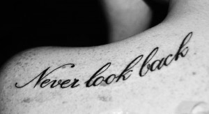 Never look back” quote tattoo on girls left shoulder written in a ...