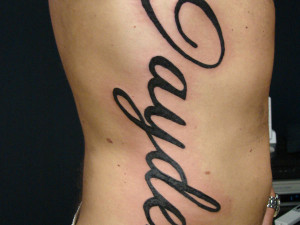 ... lines with graceful curves make up this vertical design text tattoo