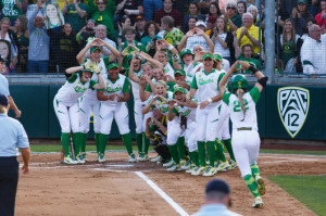 The Oregon Ducks welcome home third baseman Courtney Ceo (22) after ...