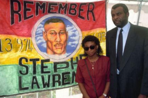 ... doreen and neville lawrence stand beside a poster of stephen lawrence