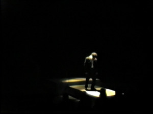 Abandoned by the Chorus, Kreon fades into darkness.