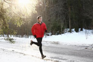 Runner on forest snowy road in the morning - Stanislaw Pytel/Digital ...