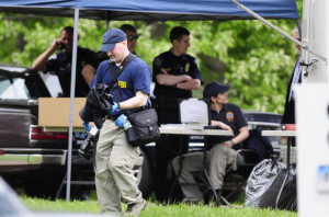 Federal and local law enforcement authorities search the Manchester ...