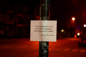 Paper with quotation on a traffic light post on St. Denis St.
