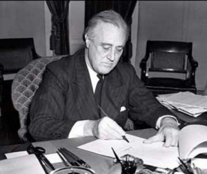 President Franklin D. Roosevelt signs the Lend-Lease bill to give aid ...