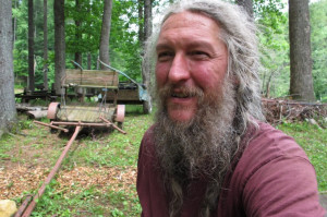 Eustace Conway sits near horse-drawn farm implements at his Turtle ...