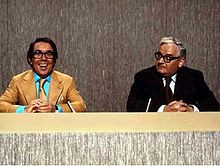 ... left, with partner Ronnie Barker in their regular news anchor spoof