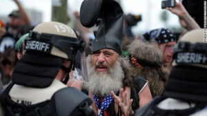 Protester Vermin Supreme talks with riot police at the Republican ...
