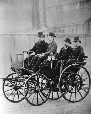 Wilhelm Maybach and Paul Daimler in the first four-wheeled Daimler ...